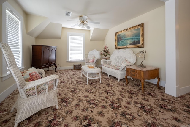 living area featuring ceiling fan and carpet