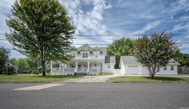 view of front facade with a garage, a front yard, and covered porch