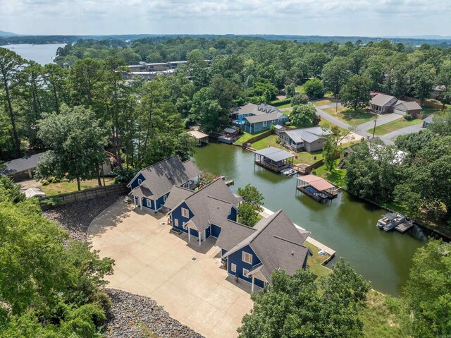 rear view of property featuring a yard, a patio, and a water view