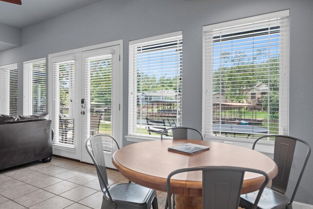 dining room featuring light tile patterned flooring and french doors