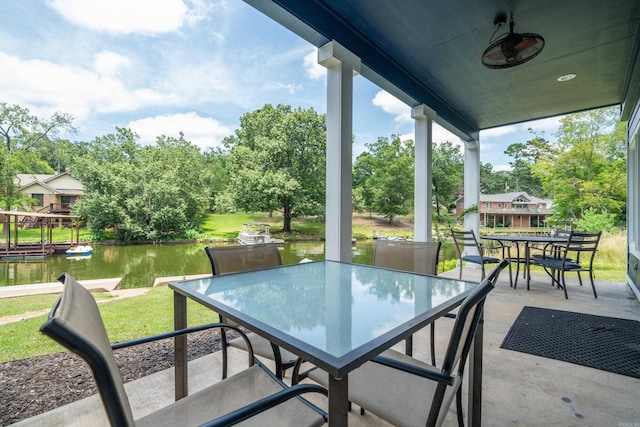 view of patio / terrace featuring ceiling fan and a water view