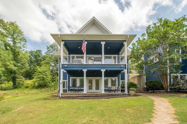 back of house featuring a balcony, french doors, a yard, ceiling fan, and central air condition unit