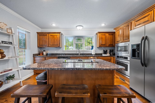 kitchen with sink, dark wood-type flooring, a healthy amount of sunlight, and black appliances