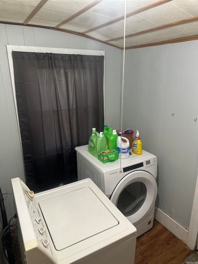 washroom with hardwood / wood-style flooring and separate washer and dryer