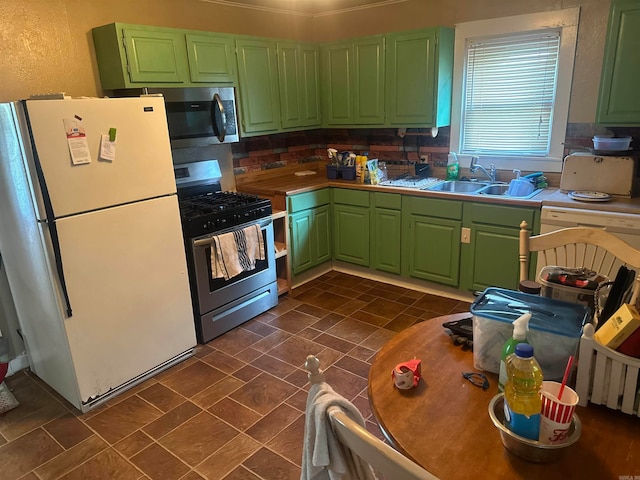 kitchen with appliances with stainless steel finishes, backsplash, and green cabinetry