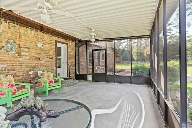 unfurnished sunroom featuring ceiling fan