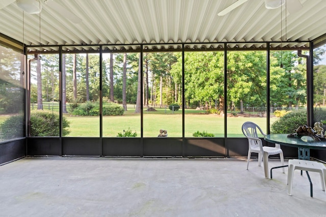 unfurnished sunroom with ceiling fan