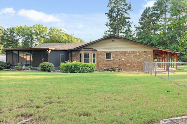 view of front of home featuring a front lawn and a sunroom