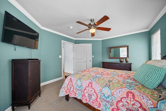 carpeted bedroom featuring ornamental molding and ceiling fan