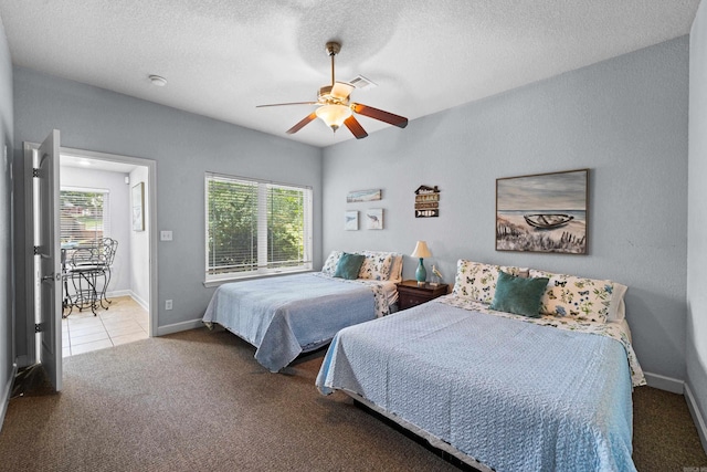 carpeted bedroom with a textured ceiling and ceiling fan