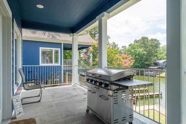 view of patio / terrace with area for grilling and a water view