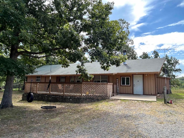 view of front facade with a patio and a fire pit