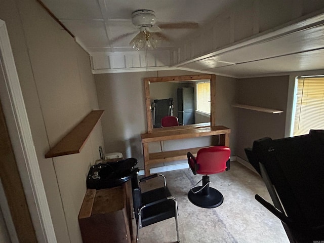 living room featuring ceiling fan and concrete flooring