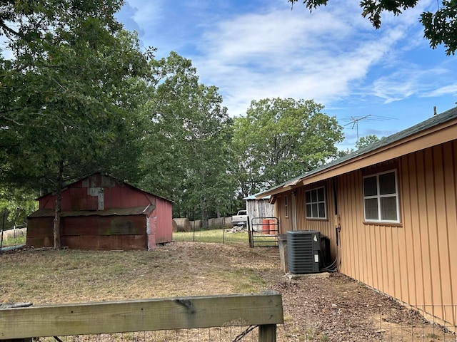 view of yard featuring an outbuilding and central AC