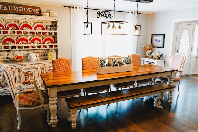 dining area with plenty of natural light, hardwood / wood-style floors, and ornamental molding