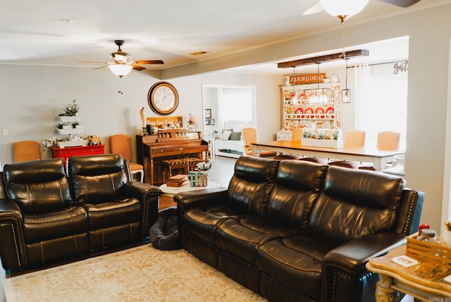 living room with ceiling fan, ornamental molding, and carpet flooring