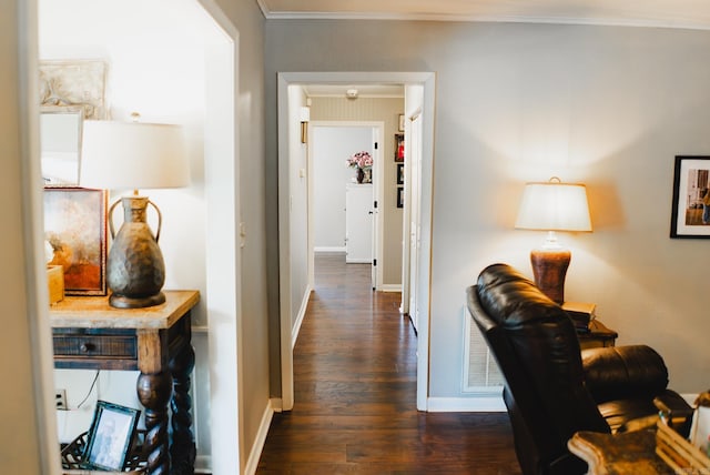 hall featuring dark wood-type flooring and ornamental molding