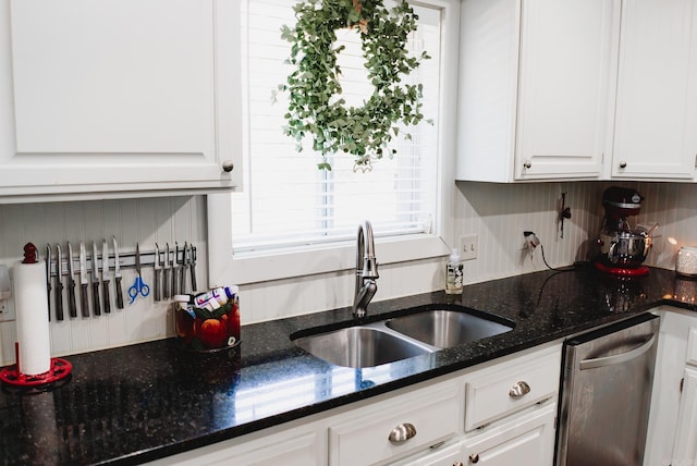 kitchen featuring white cabinets, sink, dark stone countertops, and dishwasher