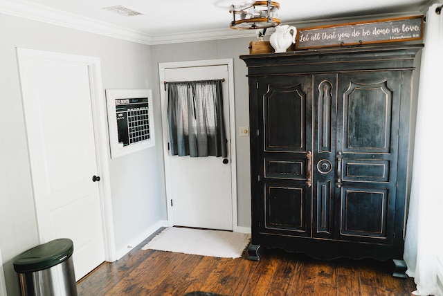 entrance foyer with dark hardwood / wood-style flooring and ornamental molding