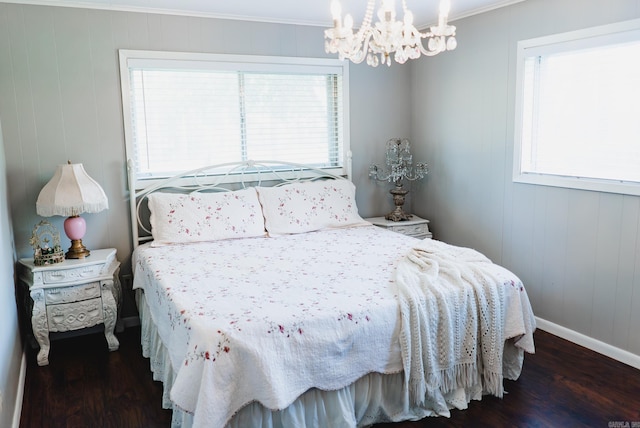 bedroom with hardwood / wood-style flooring, crown molding, and multiple windows