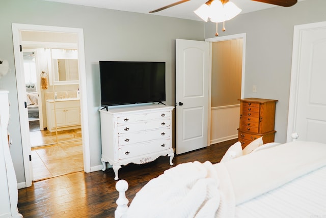 bedroom featuring ceiling fan, sink, connected bathroom, and dark hardwood / wood-style flooring