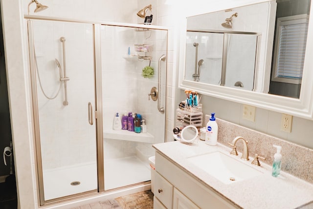 bathroom featuring vanity and a shower stall