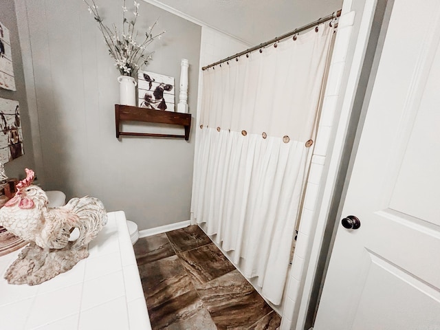 bathroom with curtained shower and toilet