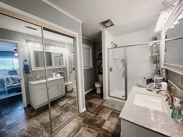 bathroom with a shower with door, toilet, tile patterned flooring, ornamental molding, and a textured ceiling