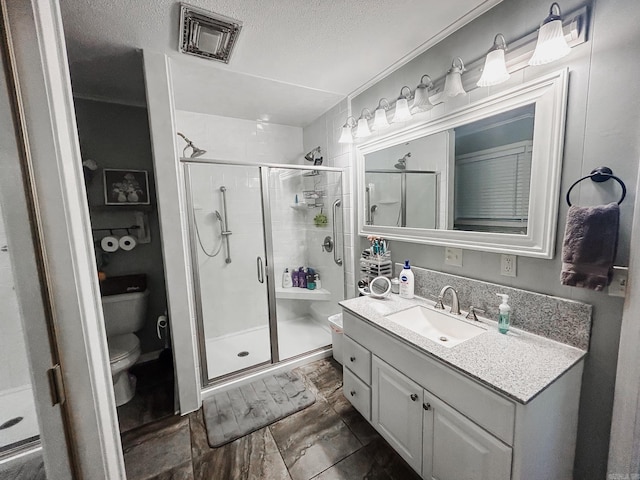 bathroom with toilet, tile patterned flooring, vanity, walk in shower, and a textured ceiling