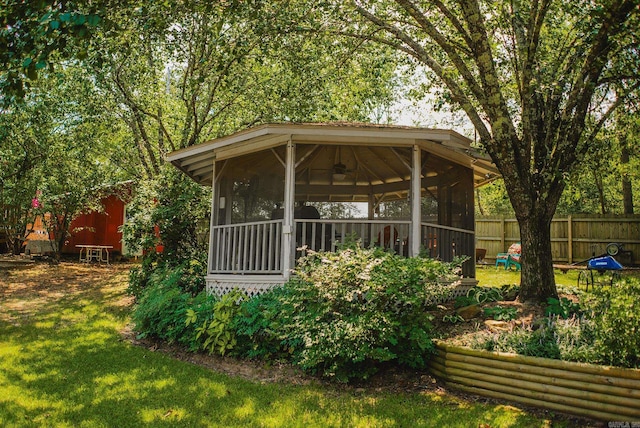 back of house with a lawn and a sunroom