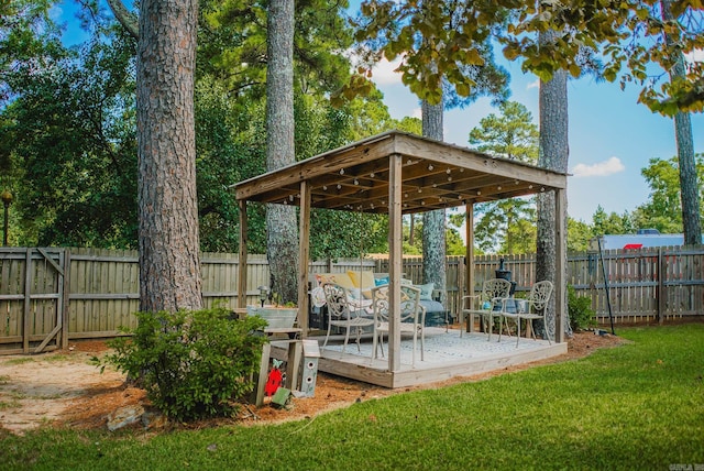 view of yard with a gazebo, a fenced backyard, and a wooden deck