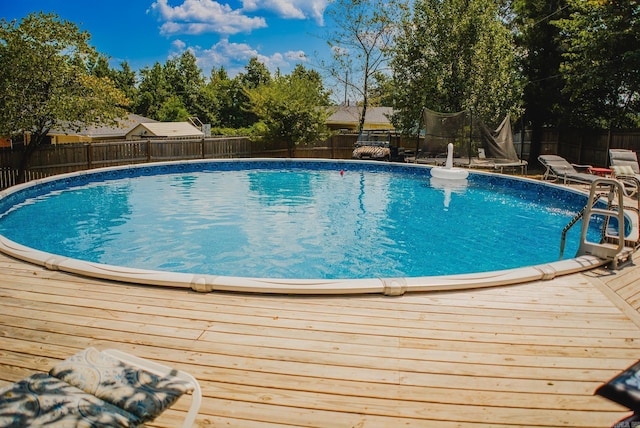 view of pool with a fenced in pool, a trampoline, and a fenced backyard