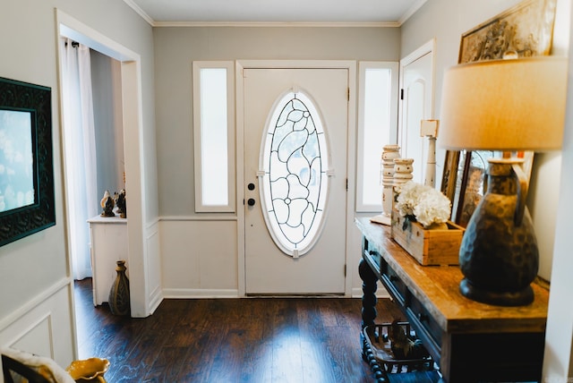 foyer featuring dark hardwood / wood-style flooring, plenty of natural light, and ornamental molding