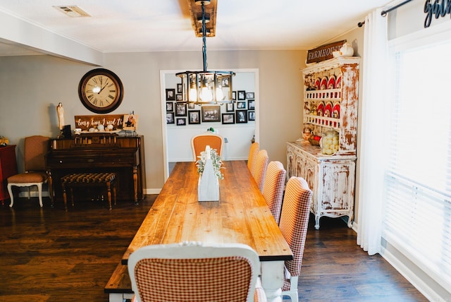 dining area featuring wood-type flooring and a notable chandelier