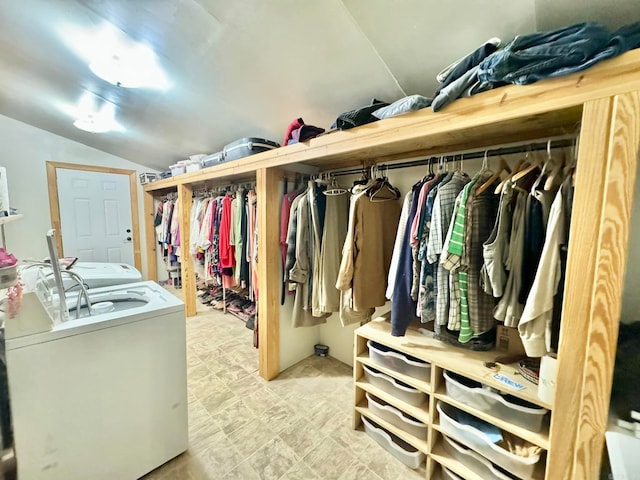 walk in closet featuring light tile patterned floors, washer and dryer, and lofted ceiling