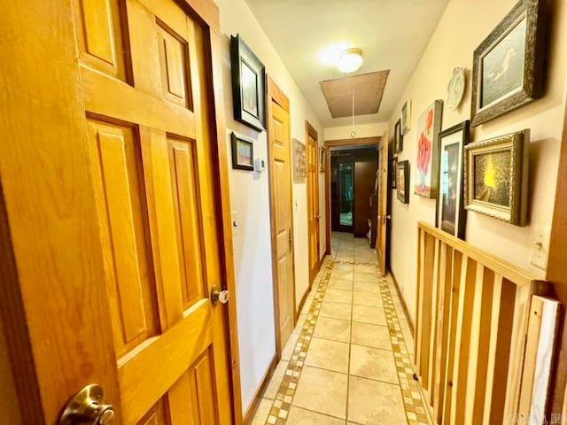 1499 Sutterfield Rd, Fox, AR 72051 - hall with inlaid floor details, attic access, light tile patterned floors, and baseboards