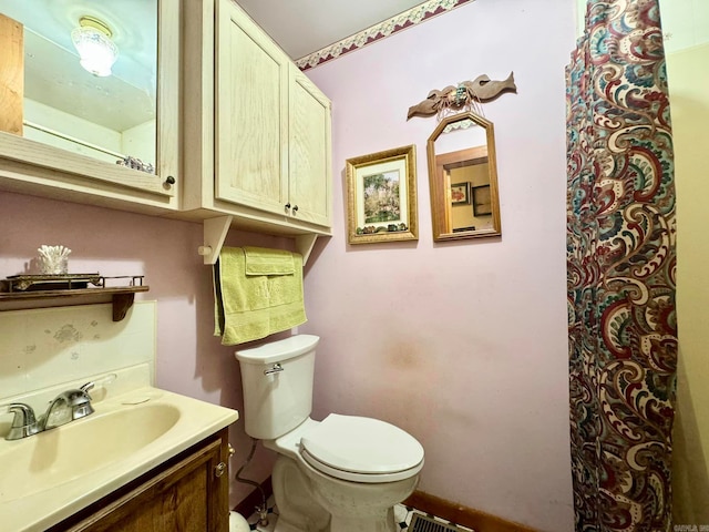 bathroom featuring toilet and vanity