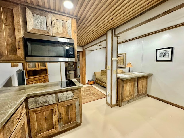 1499 Sutterfield Rd, Fox, AR 72051 - interior space with stainless steel microwave, concrete flooring, wood ceiling, and black electric stovetop