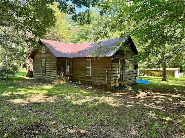 back of property featuring a lawn