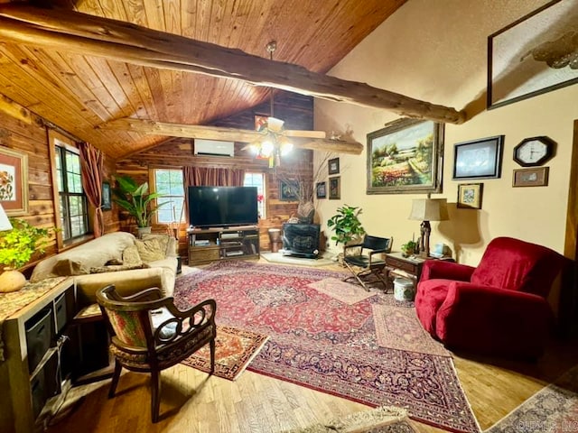 living room featuring ceiling fan, wooden walls, lofted ceiling with beams, and wood-type flooring