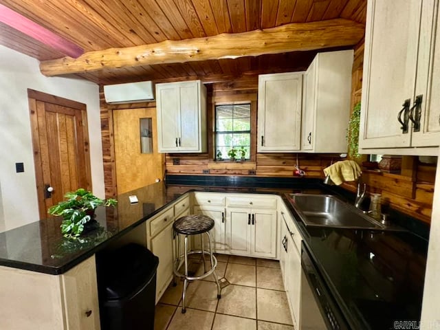 kitchen featuring beam ceiling, wooden ceiling, light tile patterned floors, sink, and kitchen peninsula