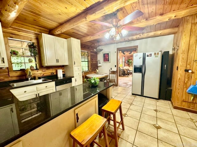 kitchen with sink, beam ceiling, wooden ceiling, ceiling fan, and stainless steel fridge