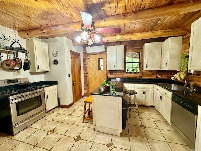 kitchen with ceiling fan, appliances with stainless steel finishes, wooden ceiling, sink, and beamed ceiling