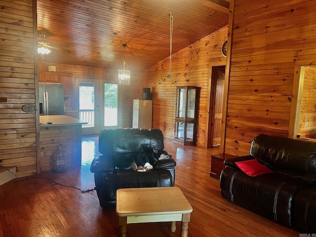 living area featuring wooden ceiling, wooden walls, vaulted ceiling, and wood finished floors