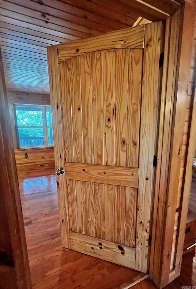 room details with wood finished floors and wooden walls