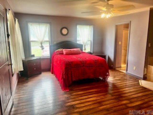 bedroom with a ceiling fan and wood finished floors