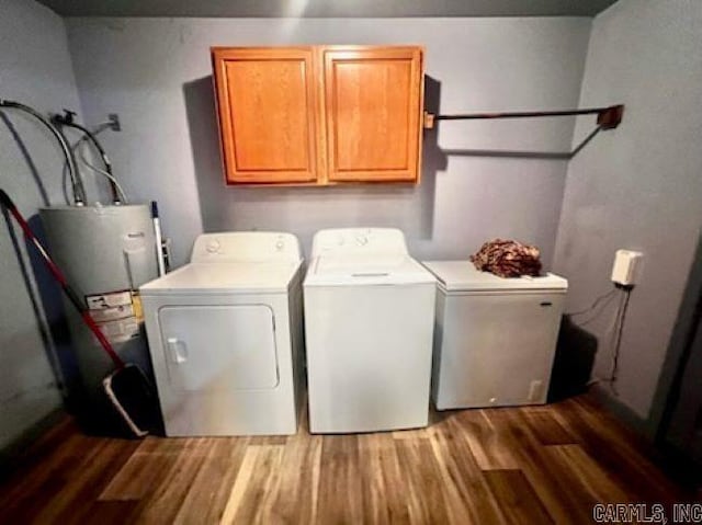 laundry room with light wood-type flooring, washing machine and clothes dryer, water heater, and cabinets