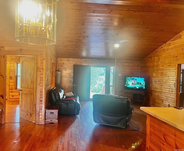 living room with wood walls, hardwood / wood-style flooring, and lofted ceiling