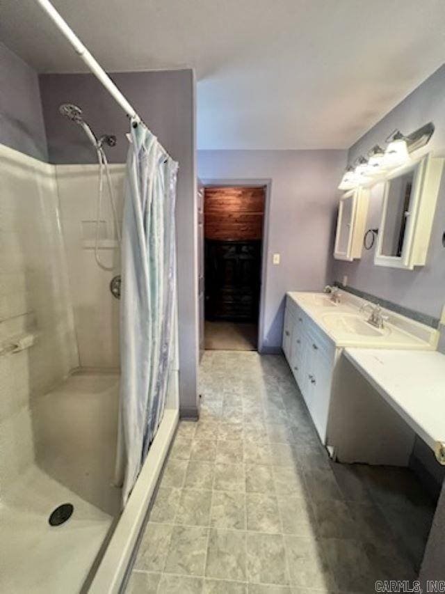 bathroom with curtained shower and vanity