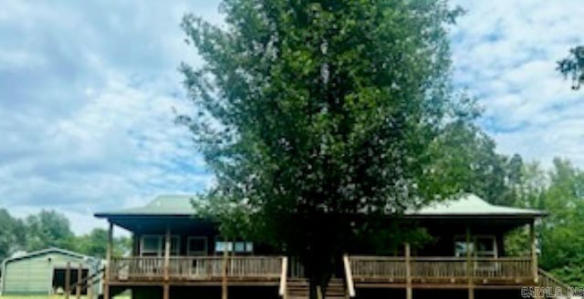 rear view of house featuring a wooden deck